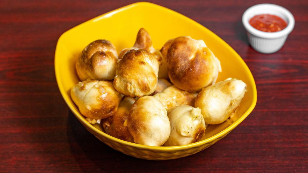 Garlic Knots · Warm bread knots brushed with garlic-infused extra virgin olive oil. Choice marinara or ranch.