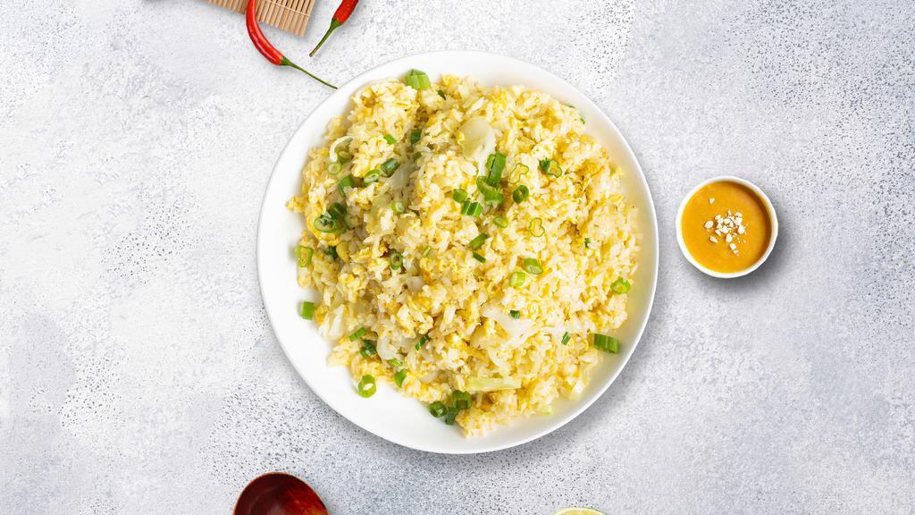 Edgy Eggy Fried Rice · Egg pan-fried with steamed rice, egg, peas, and green onions.