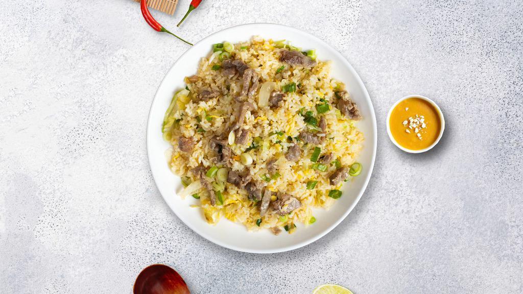 Beefed Up Fried Rice · Thinly sliced beef pan-fried with steamed rice, egg, peas, and green onions