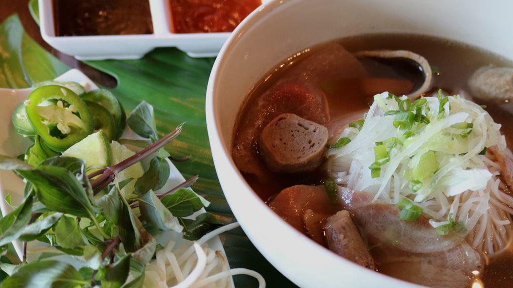 Beef Pho · 100% rare beef and brisket, tripe, meatballs, scallions, white onions, in a beef broth!