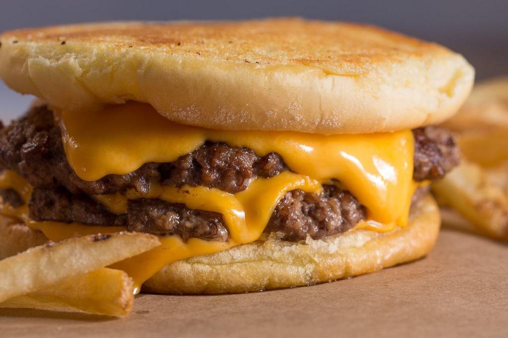Cheeeesy Burger  · We encourage you to pronounce all four E's when you order. Four slices of melted American cheese and two beef patties cooked-to-order, sandwiched between an inverted, grilled, and buttered bun.