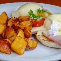 Classic Eggs Benedict · Delight fully prepared english muffins, canadian bacon, two poached eggs and topped with hol...