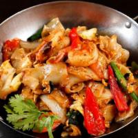 Drunken Noodle · Pan fried flat rice noodle with eggs, sweet basil, and mixed vegetables in fresh garlic chil...