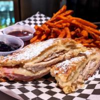 Monte Cristo · deep-fried ham, turkey & swiss; dusted with powdered sugar; served with maple syrup & season...