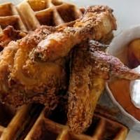 Fried Chicken and Waffles · Crispy fried chicken breast and drumstick with a fluffy Belgian waffle, and served with butt...