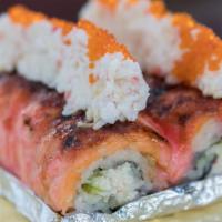 Angry Lion King · CA roll topped with salmon and special sauce and baked. Topped with crab meat and tobiko.