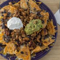 Navajo Nachos · Tortilla chips with black beans, melted cheese, guacamole, and sour cream.