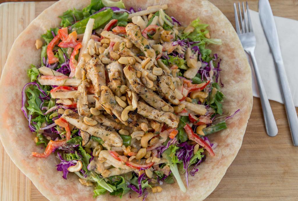 Coyotes’ Yin Yang Salad · A Southwestern, Asian salad. Jicama, red bell pepper, scallions, cashews, and snow peas, served on a bed of red cabbage, mixed greens on a warm flour tortilla with sesame dressing.