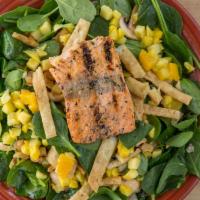 Spinach Salmon Salad · Grilled salmon, baby spinach, jicama, mushrooms, and crisp tortilla noodles in orange-chipot...