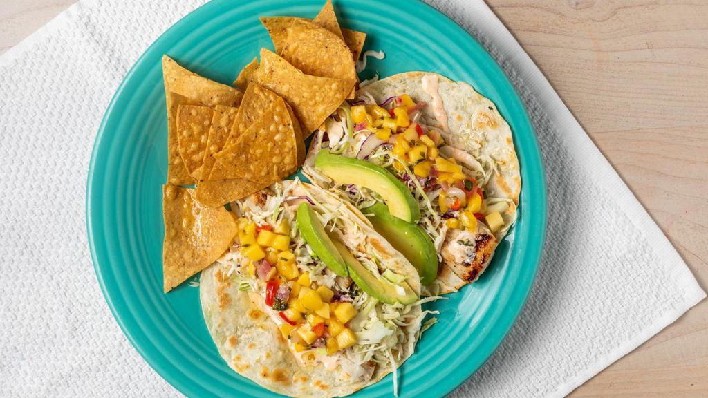 California Fish Taco Plate · Marinated charbroiled fish tacos served on a warm flour tortilla with Chef Mark's dawg sauce, cilantro-onion, agave-lime slaw, fresh avocado, mango salsa, beans, rice, chips and salsa.