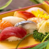 Sushi Sampler · 1 piece of eel, mackerel, salmon, tuna and tamago sushi and a spicy tuna roll.