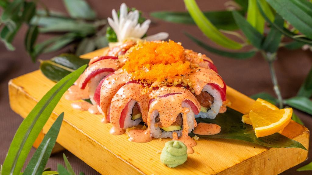 Pink Lady Roll · Spicy tuna, cucumber, topped with tuna, masago, scallions, spicy masago sauce and sesame seeds.