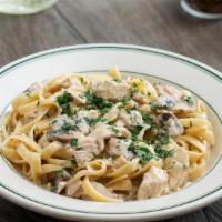Chicken Fettuccine Alfredo · Sliced chicken breast smothered in our creamy Alfredo sauce with fresh mushrooms and red oni...