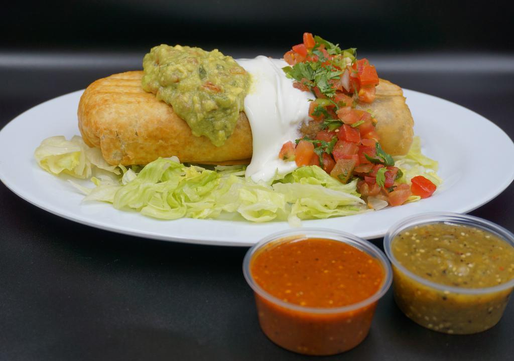 Chimichanga (deep fried burrito) · Flour tortilla, rice, beans your choice of meat, salsa, sour cream, topped with pico de gallo guacamole and sour cream. Served on top lettuce.