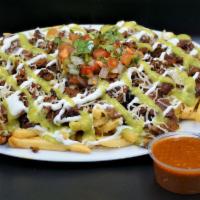 Asada Fries · French fries, cheese, sour cream, avocado sauce, carne asada, topped with another layer of s...
