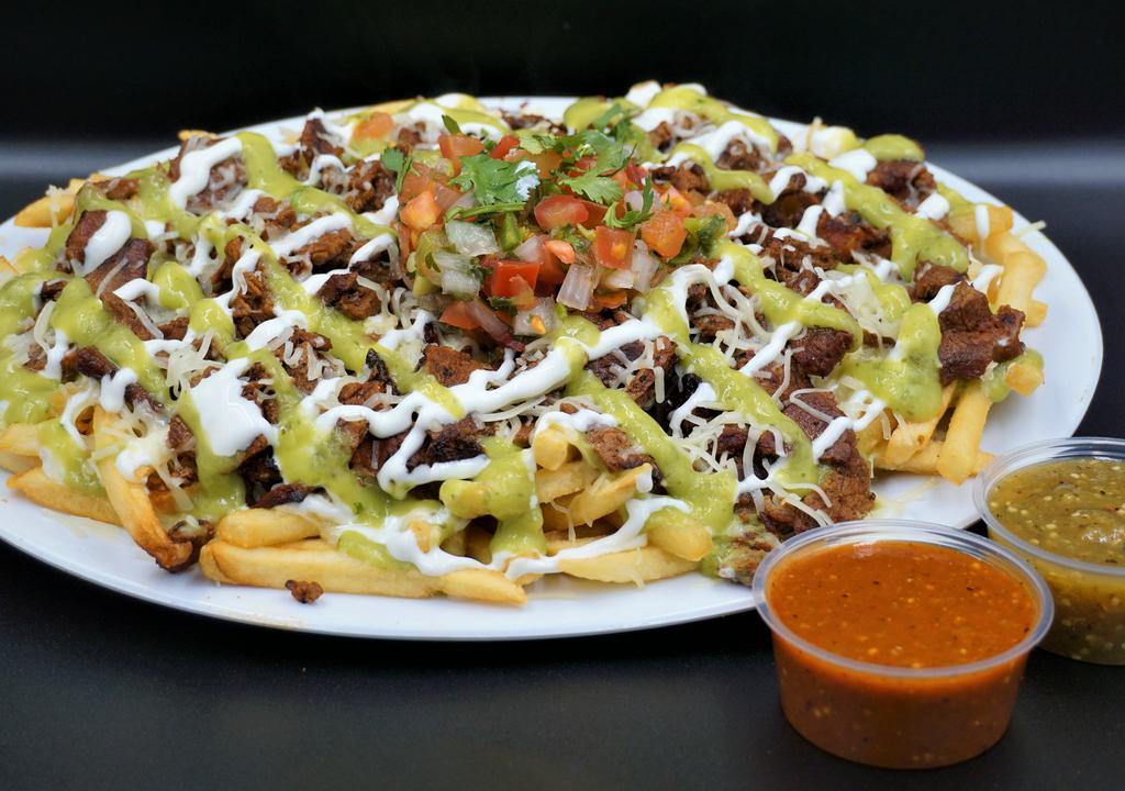 Asada Fries · French fries, cheese, sour cream, avocado sauce, carne asada, topped with another layer of sour cream, avocado sauce and pico de gallo.