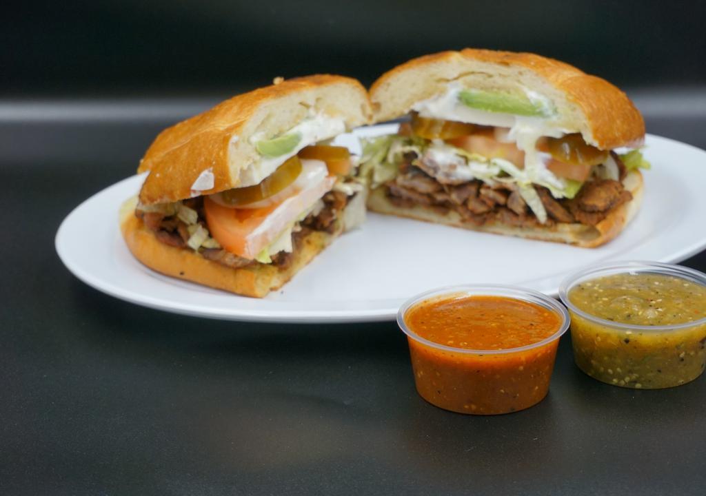 Torta · Telera bread, mayonnaise, your choice of meat, tomato, onions, jalapeño, lettuce, queso fresco (fresh Mexican cheese) and sour cream.