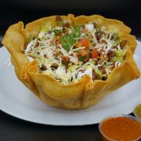 Taco Salad · Crispy flour tortilla bowl, rice beans lettuce, layer of sour cream avocado sauce your choic...