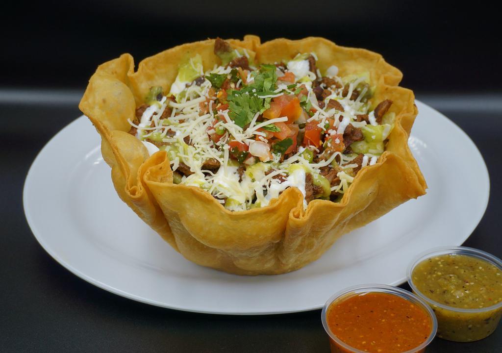 Taco Salad · Crispy flour tortilla bowl, rice beans lettuce, layer of sour cream avocado sauce your choice of meat, and another layer of of sour cream avocado sauce pico de gallo, and cheese.