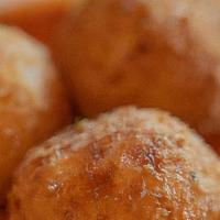 Family Style Arancini · Crispy rice balls stuffed with pistachios and mushrooms, spicy tomato sauce