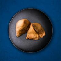 Samosa Delight · Flaky pastry turnovers filled with spiced potatoes, vegetables, and deep-fried till crisp an...