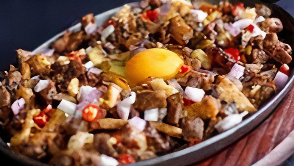 Sizzling Chicken Sisig · Sisig has been one of the best creations in Filipino cuisine. Marinated with ginger, onions, soy sauce, vinegar, lemon, and jalapeno. Twice cooked, griddled then, chopped and griddled again. Topped with a touch of mayonnaise.