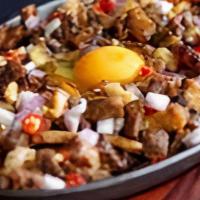 Pork Sisilog · diced twice cooked griddled pork sisig. This meal served with Garlic Rice and 2 eggs.