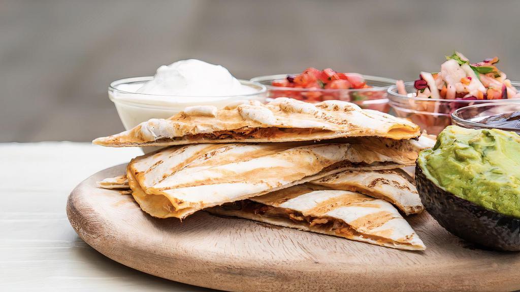 Classic Quesadilla · Our crisp flour tortilla loaded with cheese and your choice of protein.