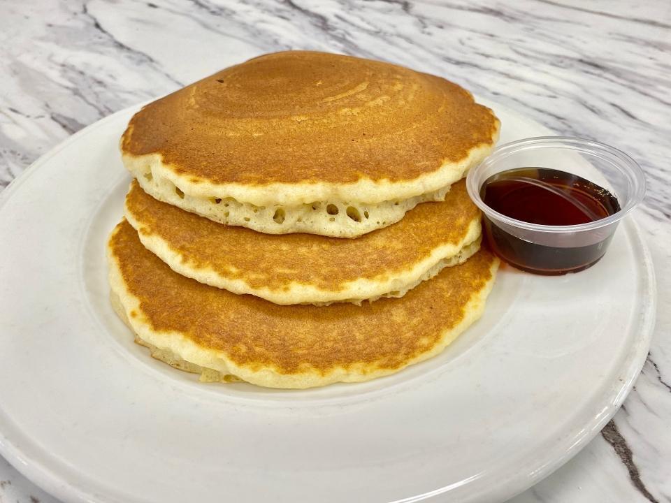 FULL STACK BUTTERMILK · Three buttermilk pancakes, butter and syrup.