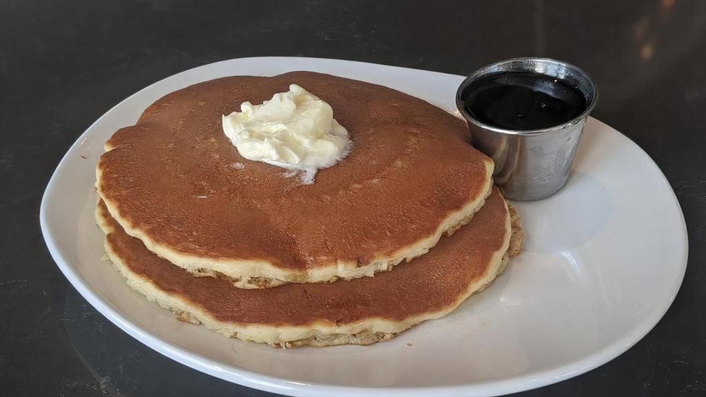 SHORT STACK BUTTERMILK · Two buttermilk pancakes, butter and syrup.