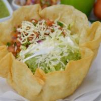 TACO SALAD · Beans, rice, sour cream, guacamole, cheese, lettuce, tomato, choice of meat.