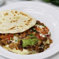 SUPER QUESADILLA · With sour cream, guacamole, cheese, and choice of meat.