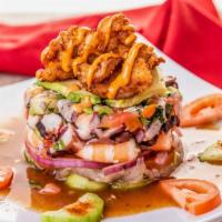 Torre de Mariscos · Spicy. Cooked shrimp, octopus, cucumber broth, tomato, onion, coriander, chili.