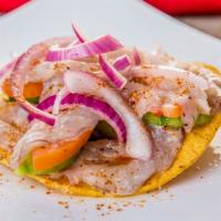 Tostada de Aguachile · Spicy. Shrimp, cucumber, tomato, onion, coriander and chili on tostada (Fried Tortilla) and ...