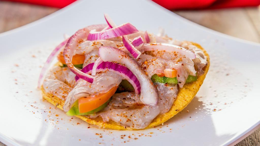 Tostada de Aguachile · Spicy. Shrimp, cucumber, tomato, onion, coriander and chili on tostada (Fried Tortilla) and spicy.