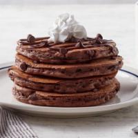 Chocolate Chocolate Chip Pancakes  · Four chocolate pancakes filled with chocolate chips, topped with a drizzle of chocolate syru...