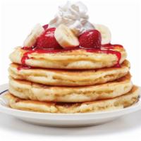 Strawberry Banana Pancakes · Four buttermilk pancakes filled with fresh banana slices. Topped with glazed strawberries & ...
