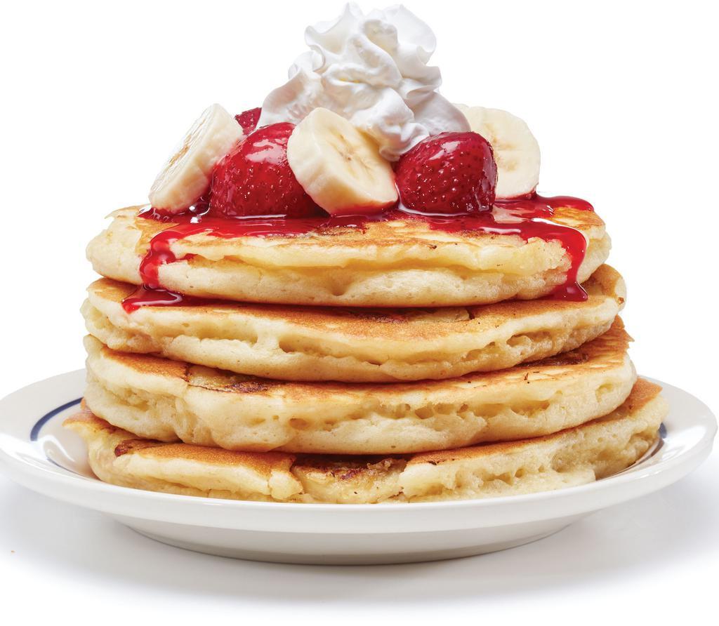 Strawberry Banana Pancakes · Four buttermilk pancakes filled with fresh banana slices. Topped with glazed strawberries & more banana slices.