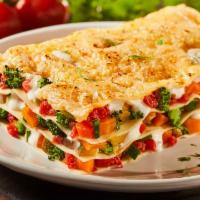 Vegetarian Lasagna · Made with roasted vegetables, zucchini, carrots, onions, and spinach in a marinara base sauce.