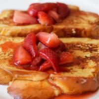 Strawberry French Toast · Fresh baked bread dipped in a rich egg batter topped with strawberries with a side of butter...