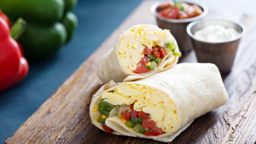 Vegetarian Breakfast Burrito · Fresh eggs, spinach, onions, tomatoes, potatoes, garlic, and cheese wrapped in a fresh made tortilla.