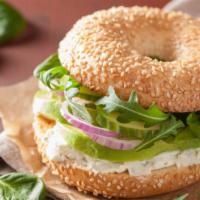Bagel with Cream Cheese and Avocado · Fresh made bagel smothered in cream cheese and avocado.