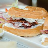 Bagel with Cream Cheese and Bacon · Fresh made bagel smothered in cream cheese and crispy bacon.