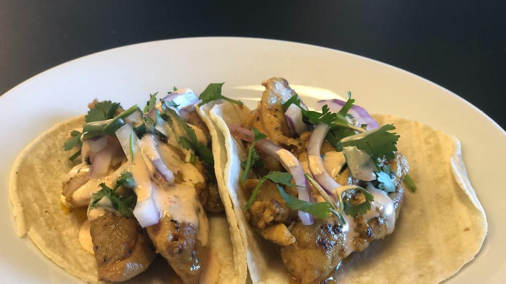 TACOS! CHICKEN · 2 CHICKEN TACOS 
Served on corn tortillas, with onion, cilantro and drizzled with sauce.