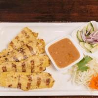 Chicken Satay · Chicken on skewers, marinated with fresh herbs and spices, served with peanut sauce and cucu...
