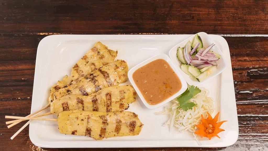 Chicken Satay · Chicken on skewers, marinated with fresh herbs and spices, served with peanut sauce and cucumber salad