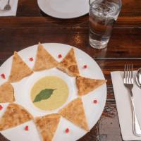 Roti with Green Curry · Pan fried roti (Asian pita bread) served with green curry dipping sauce, garnished with dice...