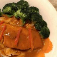 Chu Chee Salmon · Salmon in red curry sauce with steamed vegetables, topped with kafﬁr lime leaves and bell pe...
