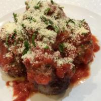 Italian-Style Meatballs · Four ground beef meatballs covered with marinara sauce, cheese, and herbs.
