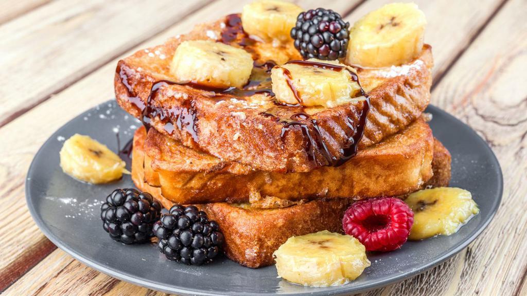Berries & Banana French Toast · 2 slices of Classic French Toast freshly prepared and cooked to perfection. Topped fresh a mix of fresh berries and banana slices and served with syrup and hint of butter.